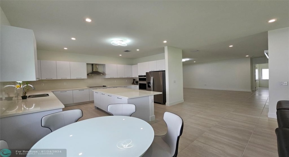 Kitchen next to tv and great room