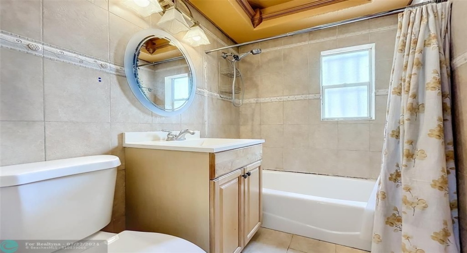 Remodeled bathroom with raised ceiling & crown molding.