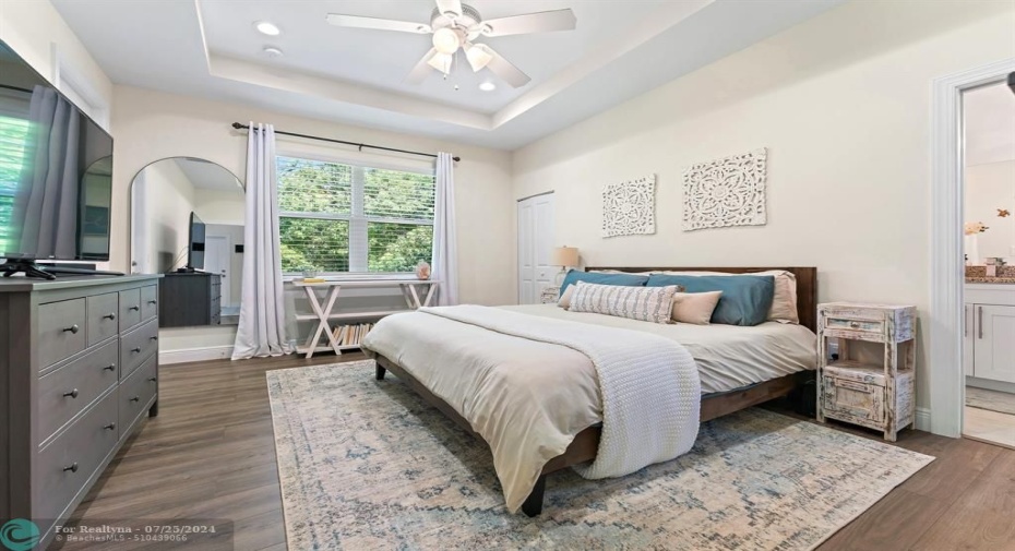 Large primary bedroom with views of the preserve & garden