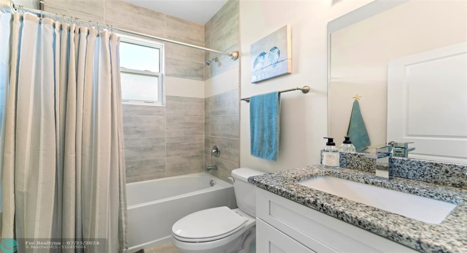 Second bathroom, situated between two linen closets (and two bedrooms)