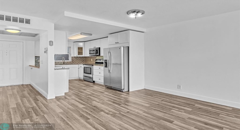 Dining Area with Foyer Entrance on left, Open Kitchen on right.