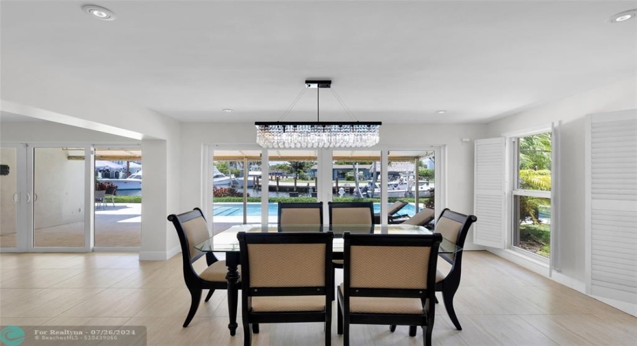 Dining room offers sliders & pool and water views