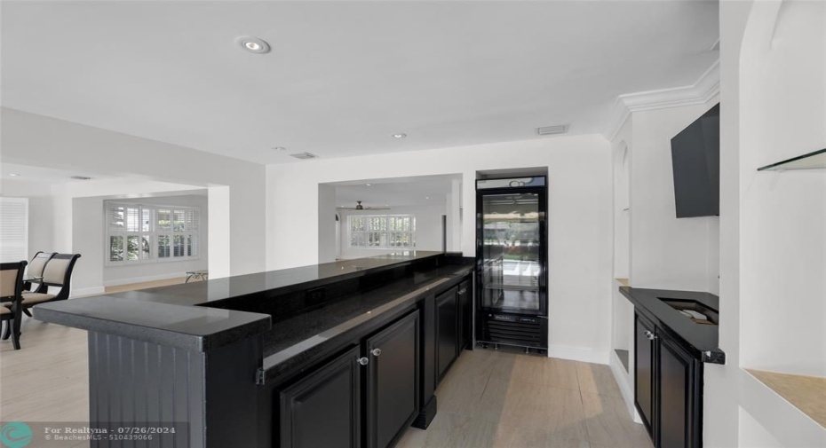 Fabulous wetbar with wine cooler and sink and tons of counter and storage space is perfect for entertaining