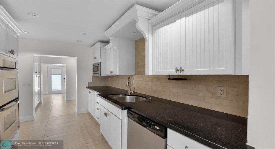 White counters offer tons of storage in kitchen