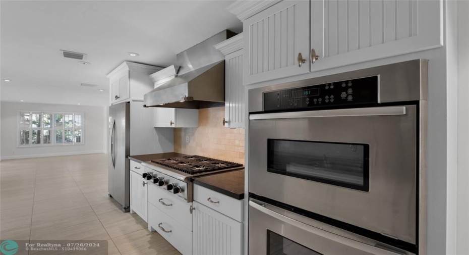 Double oven and gas range stove featured in kitchen