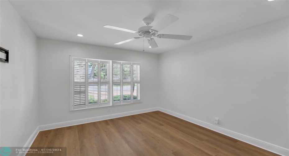 Bedroom with new flooring, plantation shutters and overhead ceiling fan