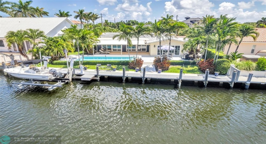Ready and waiting for your boat! Updated deep water pool home located right on the water with tropical landscaping