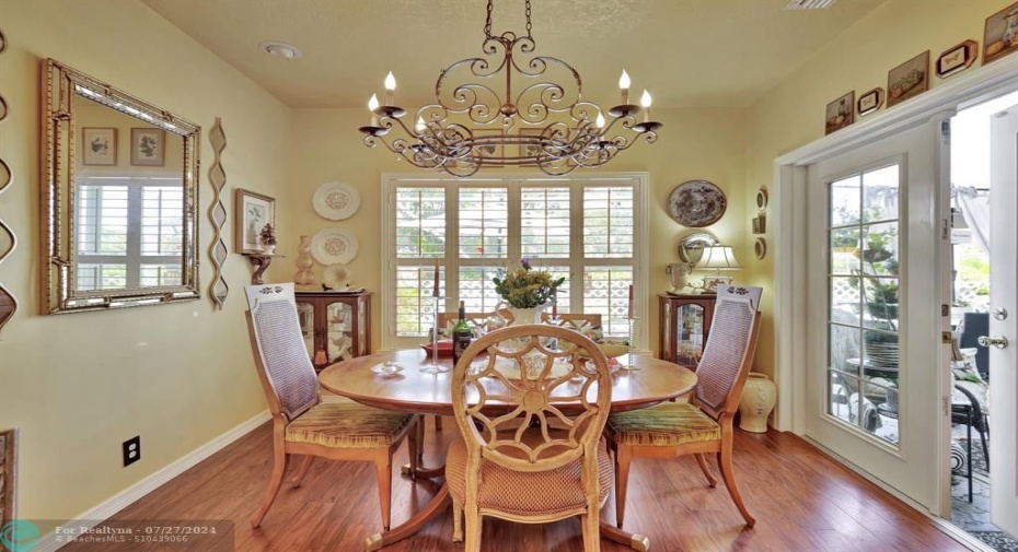 Custom shutters and French doors with impact glass to screened patio.