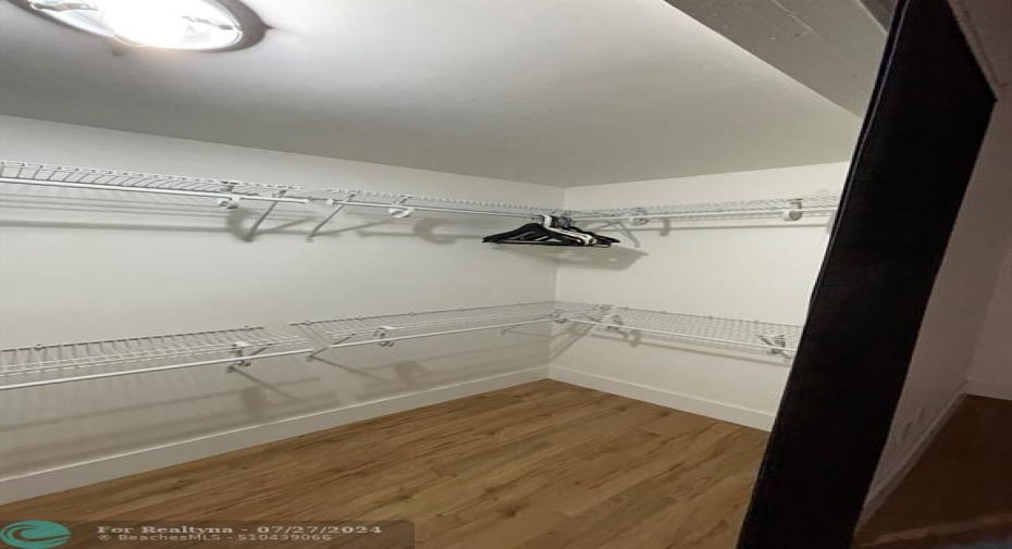 large closet in master bedroom with curtain