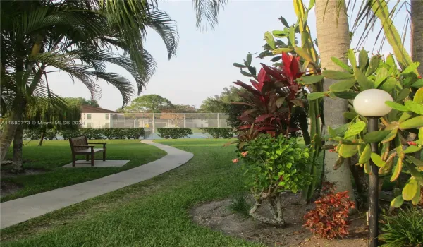 PATHWAY TO TENNIS/PICKLE-BALL COURTS AT THE END OF THE BLDG.