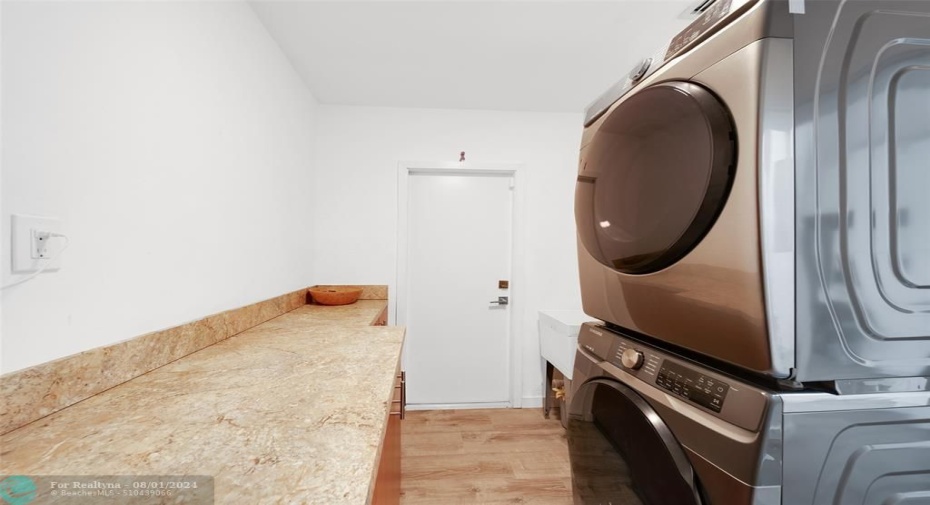 Laundry Room with Custom Cabinetry, Extra Pantry & Storage Cabinets, Soaking Tub & Full-Sized Samsung Steam/Sanitize-Washer/Dryer adjacent to the Kitchen, Both Have Impact Doors. Tankless Water Heaters.