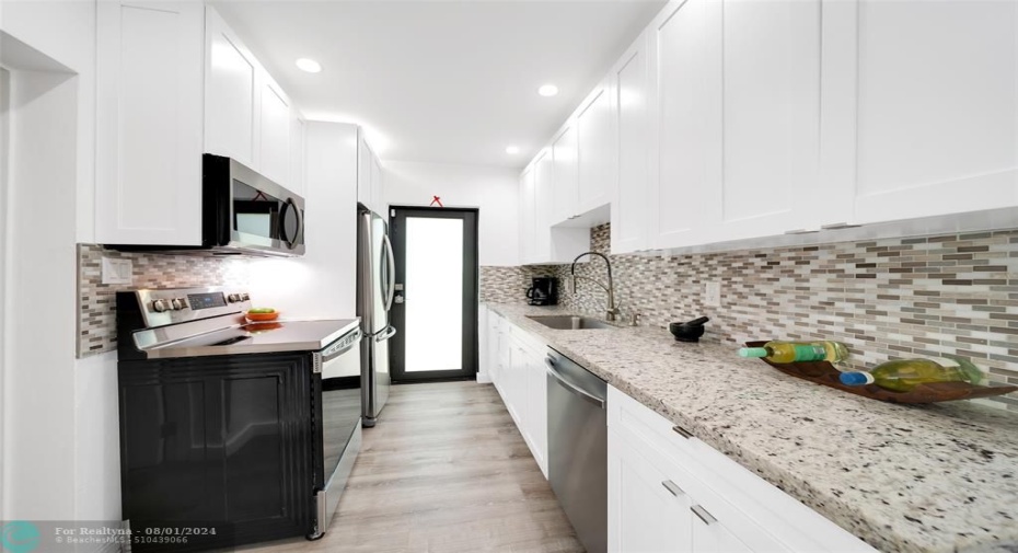 Custom & Tall Kitchen Cabinets includes Pantry Cabinets, Granite Counters & Samsung Stainless Steel Appliances. Dimmable LED Lighting throughout-2023. Laundry & Additional Cabinet Storage Room Adjacent.