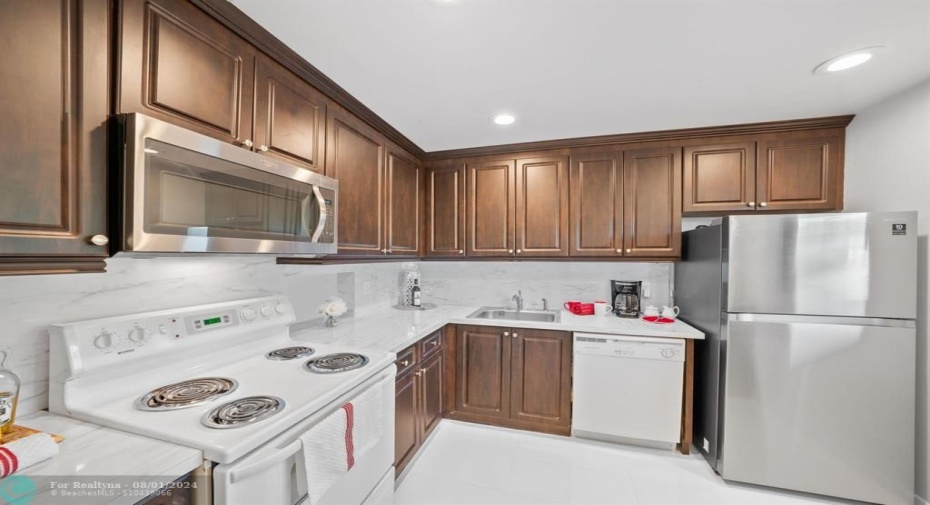 Bright, open kitchen with white backsplash and plenty of counter space.