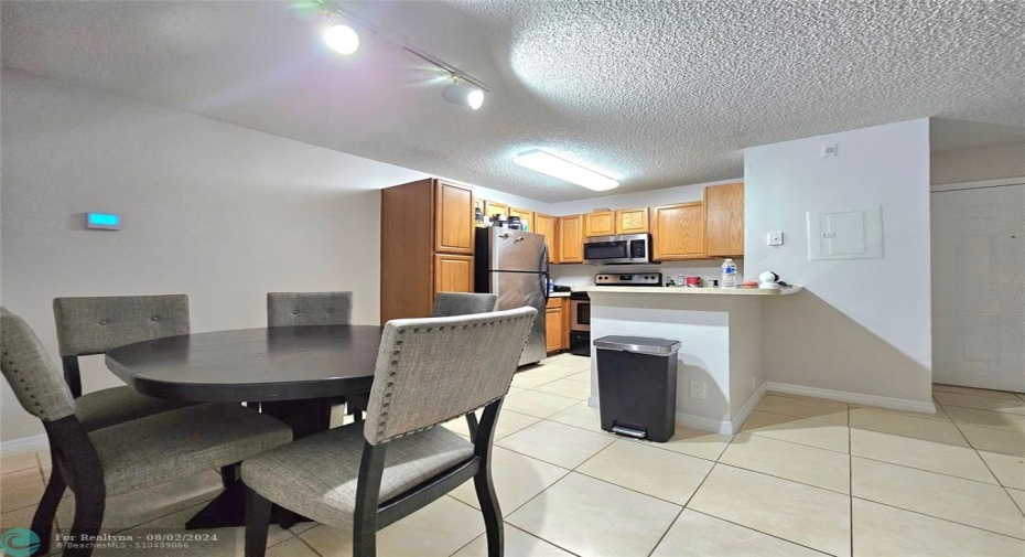 DINING ROOM AND KITCHEN AREA WITH STAINLESS STEEL APPLIANCES