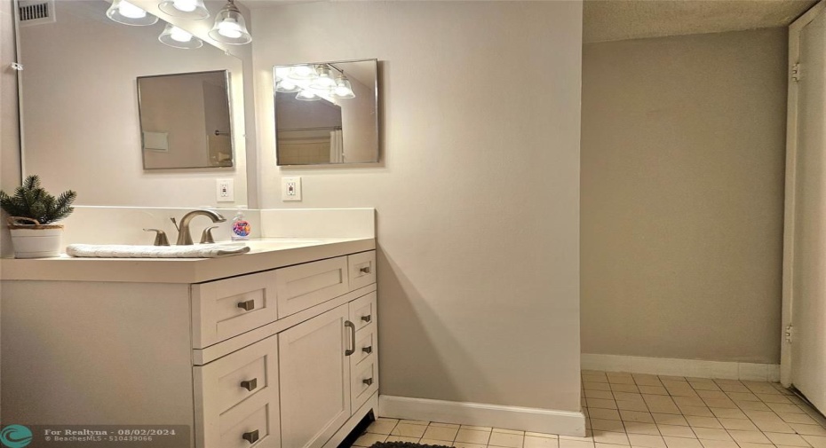 VIEW FROM THE TUB TO THE EXIT WITH LINEN CLOSET