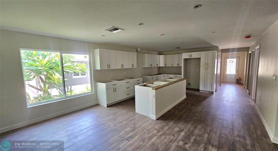 New Construction and brand new kitchen with white cabinets and wood like flooring