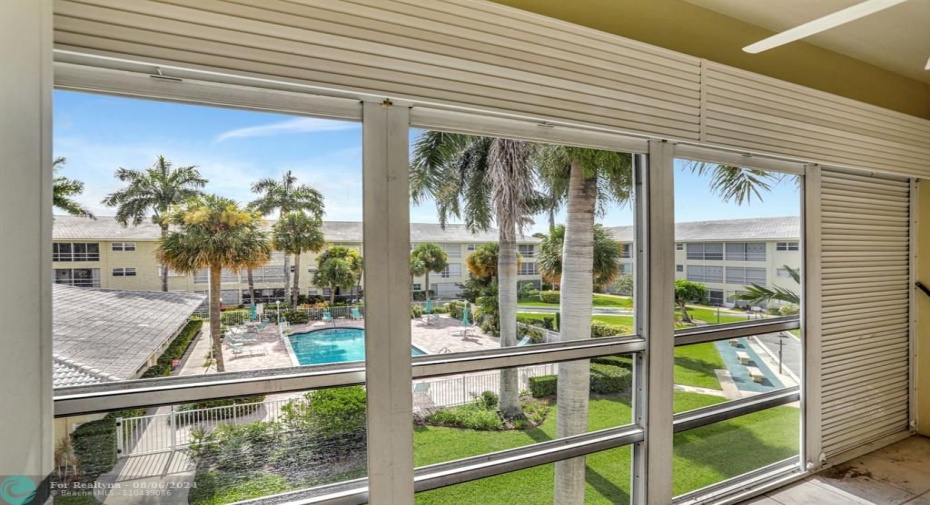 SCREENED BALCONY OVERLOOKING POOL,CLUBHOUSE AND GARDENS