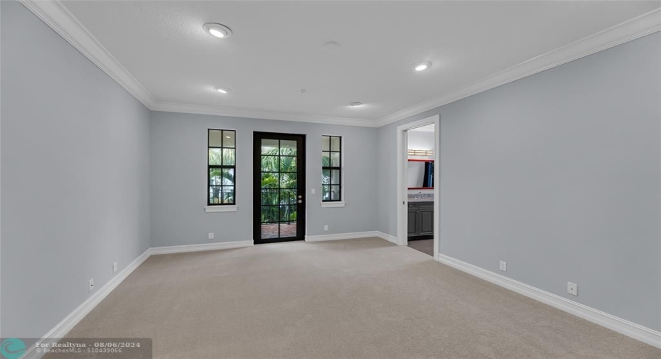 Bedroom 2 with French door to balcony and ensuite bathroom