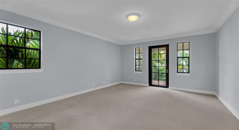 Bedroom 3 with French door to balcony overlooking pool