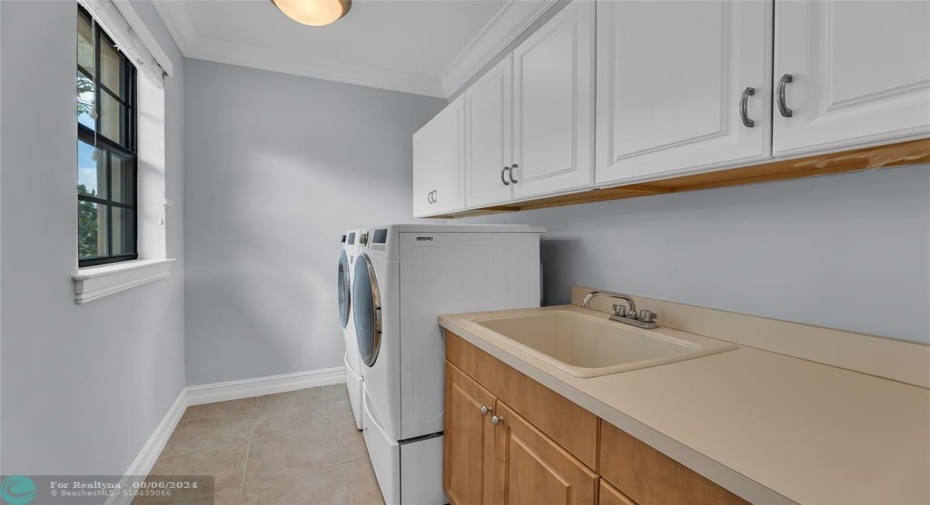 Upstairs laundry room with LG front loading washer and dryer and great storage