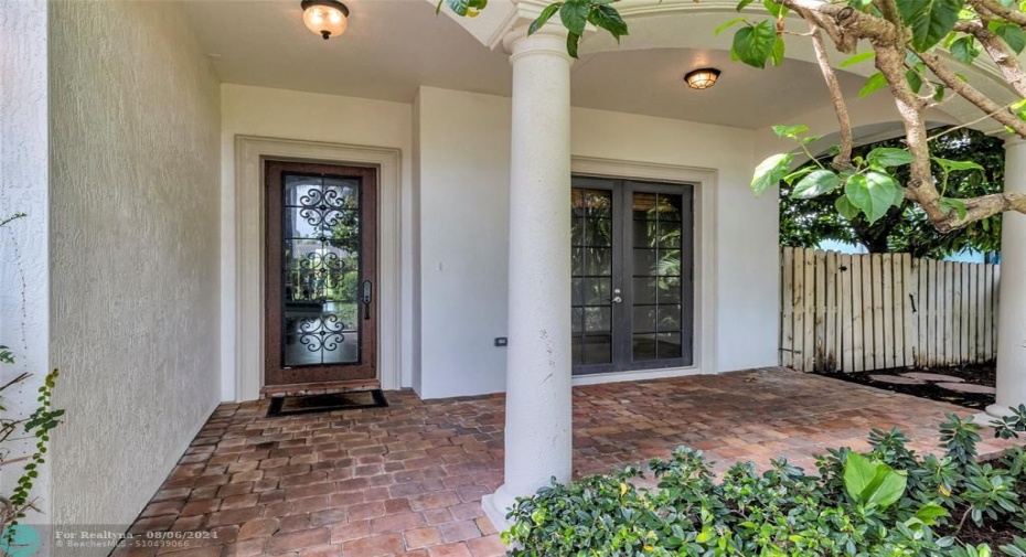 Large covered front porch with front door and additional French door access to office/den or bonus room