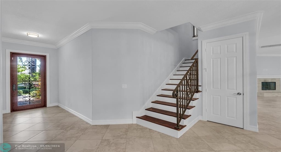 Front door into spacious foyer with stairs to second level