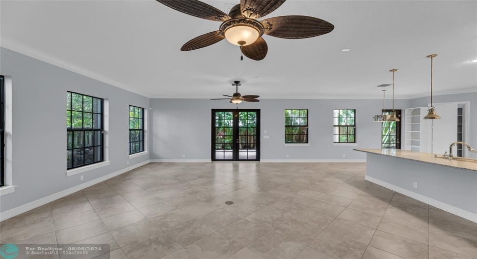 Double overhead fans offered in family room with French doors to large covered patio