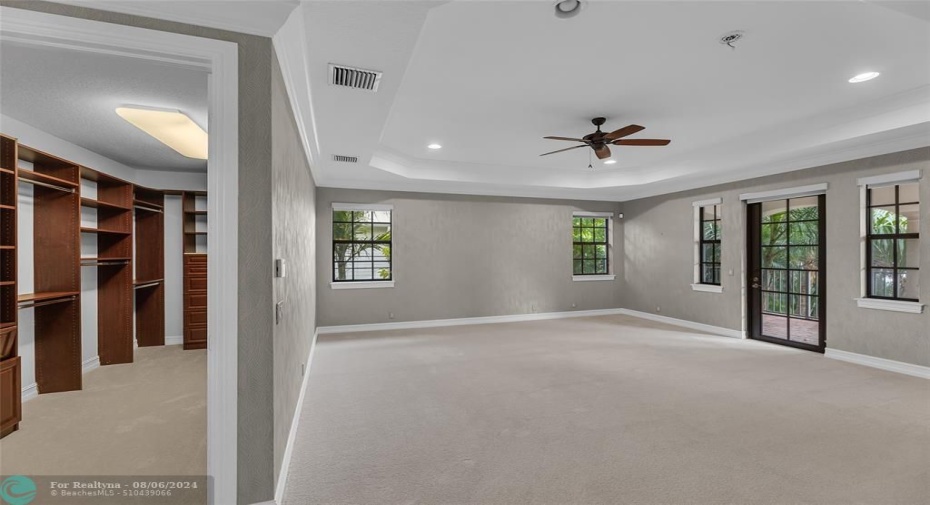 Huge master bedroom offers raised ceilings, high-hat lighting, French doors to private balcony and 2 large walk in closets.