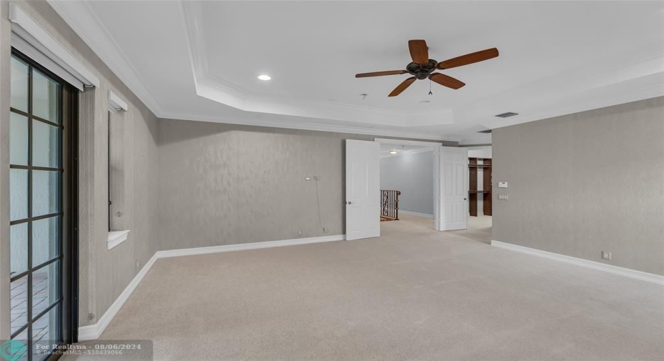 French doors in Master bedroom lead to large balcony overlooking front of home