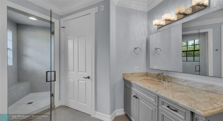 Master bathroom is large and spacious with marble counters, walk in shower with seating and separate water closet