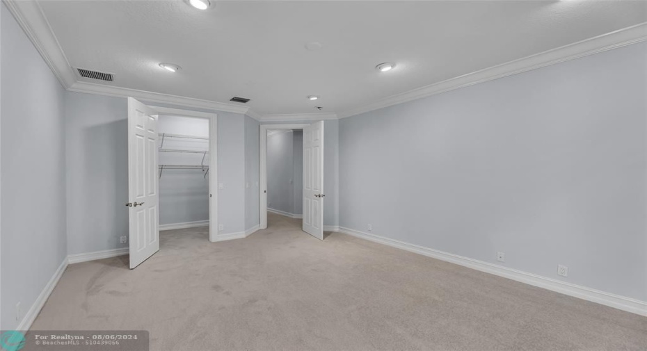 Second Bedroom with walk in closet and High-hat lighting with French doors to balcony overlook pool (not shown in picture)