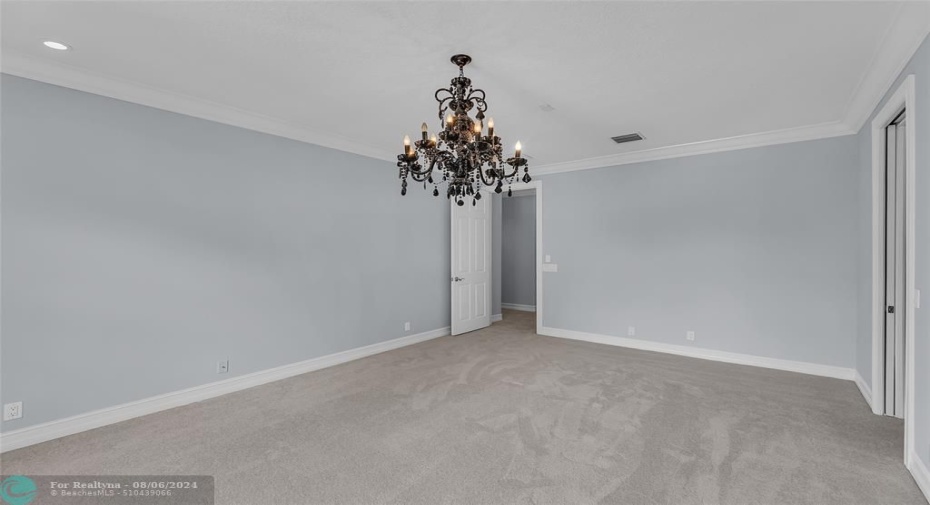 Fourth Bedroom with crown molding and gorgeous black chandelier