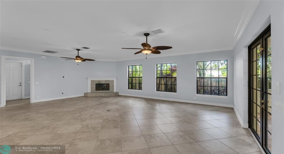 Family room is large and spacious with Marble fireplace and an abundance of natural light located right off of the kitchen