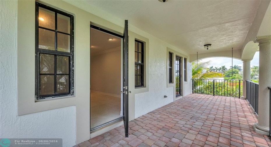 Large covered patio with French doors into Kitchen and Family room