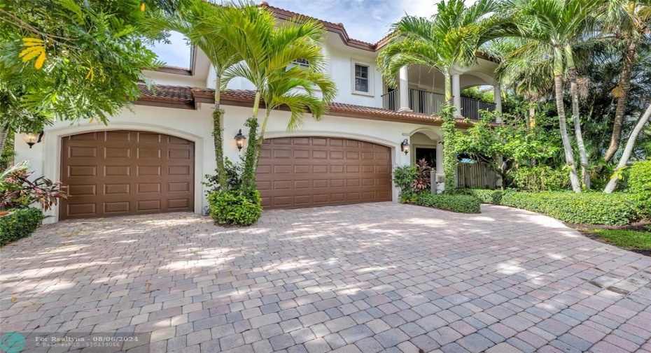 Large front pavered driveway and 3 car garage home