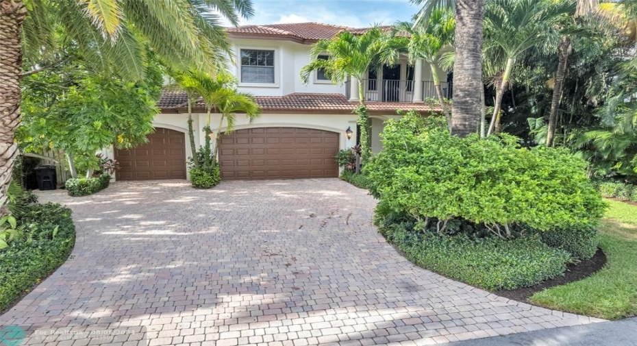 Pavered driveway with 3 car garage offering great parking for guests