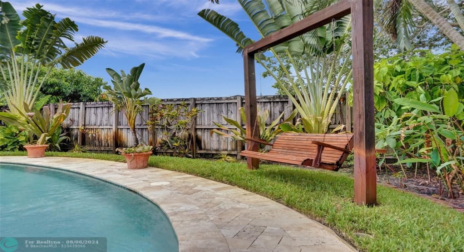 Pool deck and wood swing bench.