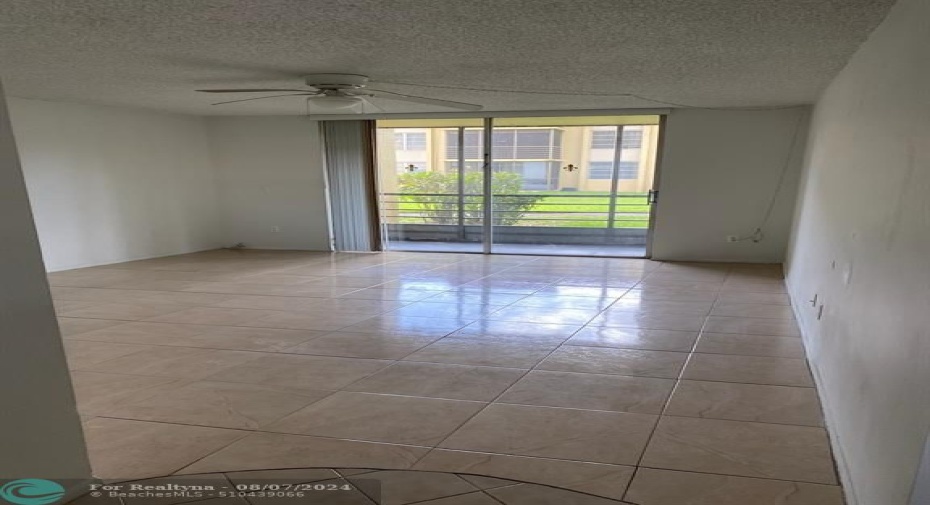 LIVING ROOM WITH SLIDER TO SCREENED PATIO