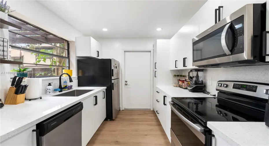 Brand new kitchen.  View of patio area and exit thereto from kitchen.