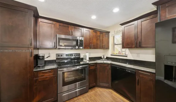 Gorgeous espresso cabinets with pantry and granite counter tops