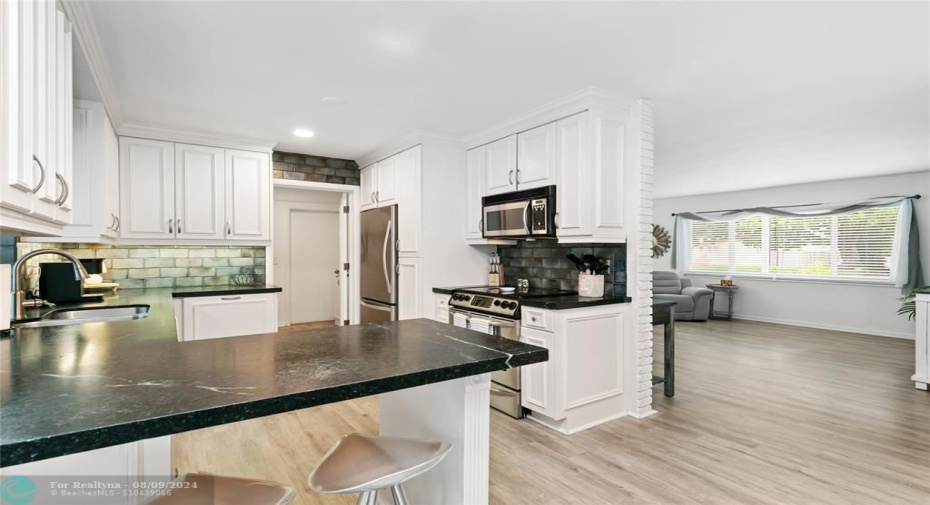 Kitchen with living room in background