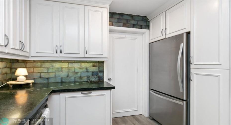 Kitchen with laundry room door in background