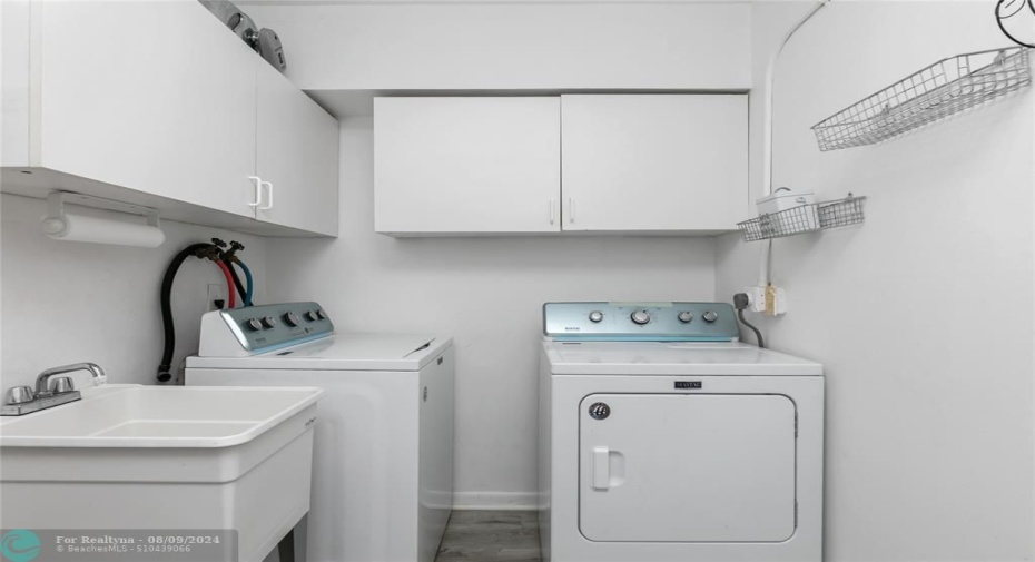 Laundry room off kitchen with lots of cabinetry. There is also more cabinetry on the reverse wall not in pic. Love a spacious laundry room ;0)