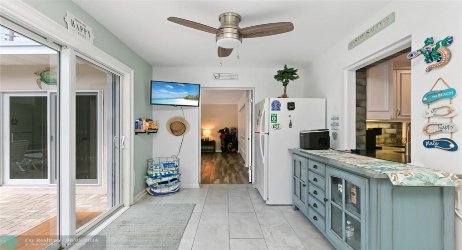 Impact enclosed breezeway area with sliders out to pool deck. Guest room doorway in background.