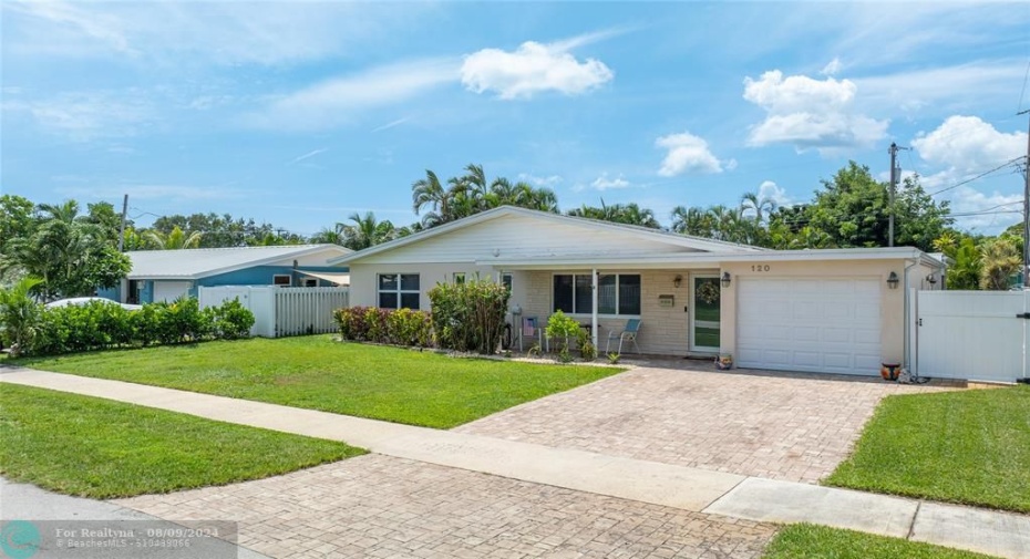 Home front facade with paved driveway and 1 car garage