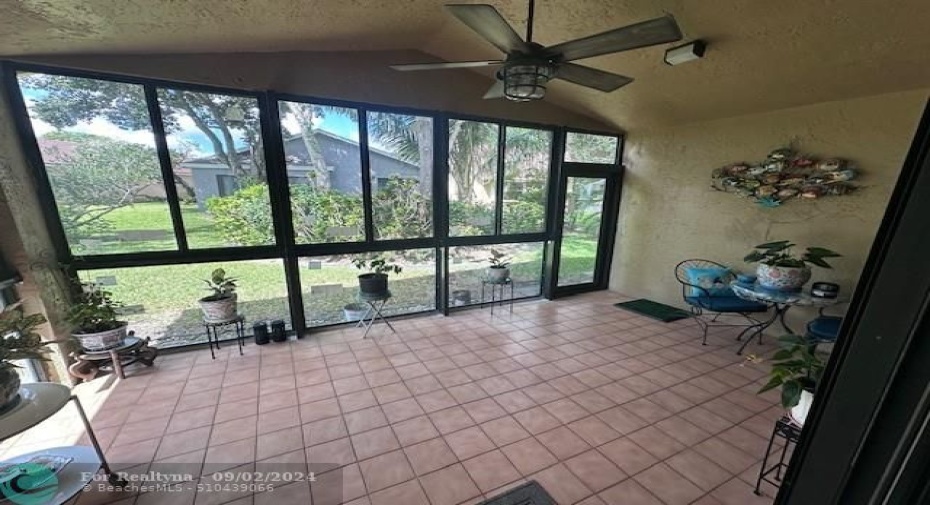 Enclosed patio with impact windows and door for extra space that can be use as a den