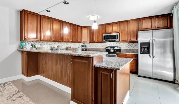 Renovated with granite, lots of cabinets & snack counter for your convenience