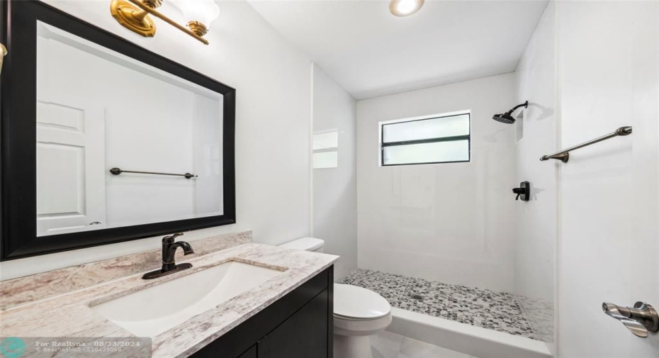 Stylish Featuring Newer Cabinet and Sleek Walk-in Shower.