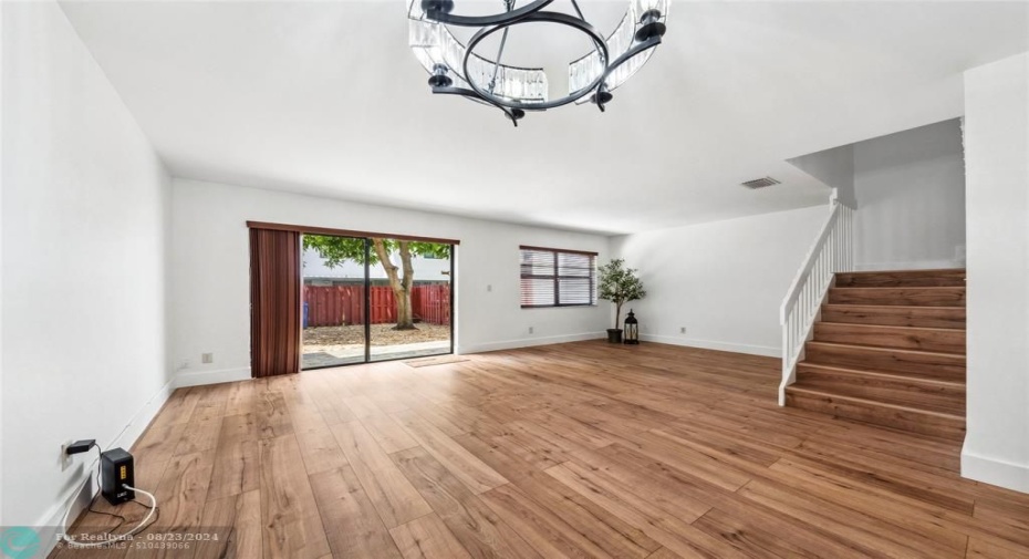 Sliding Doors Open to Backyard and Patio