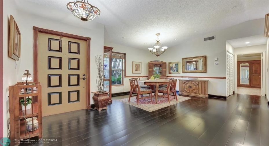 High vaulted ceilings, rich bamboo wood flooring, freshly painted walls in warm white, and details like chair rail molding all create a warm charm to welcome you home.